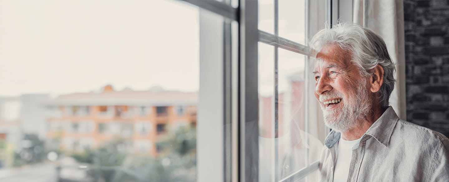 Smiling man looking out of the window