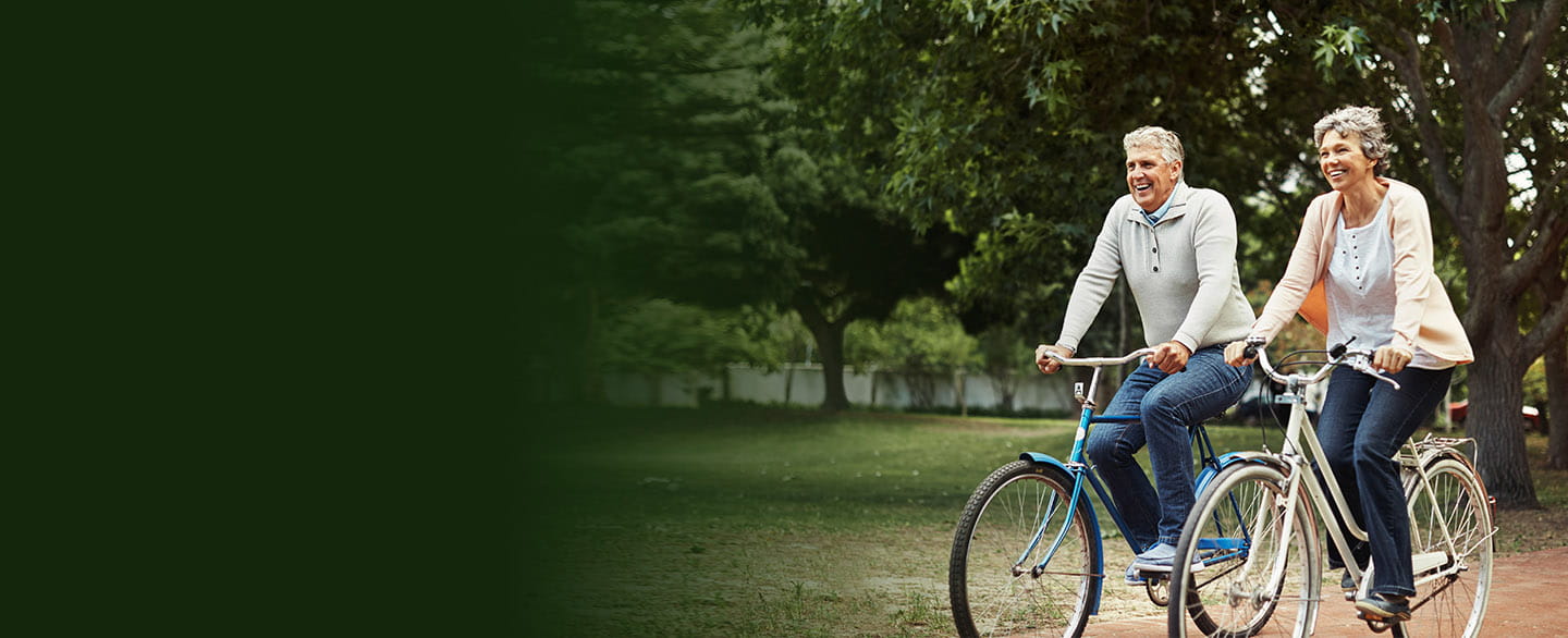Happy couple riding bikes.