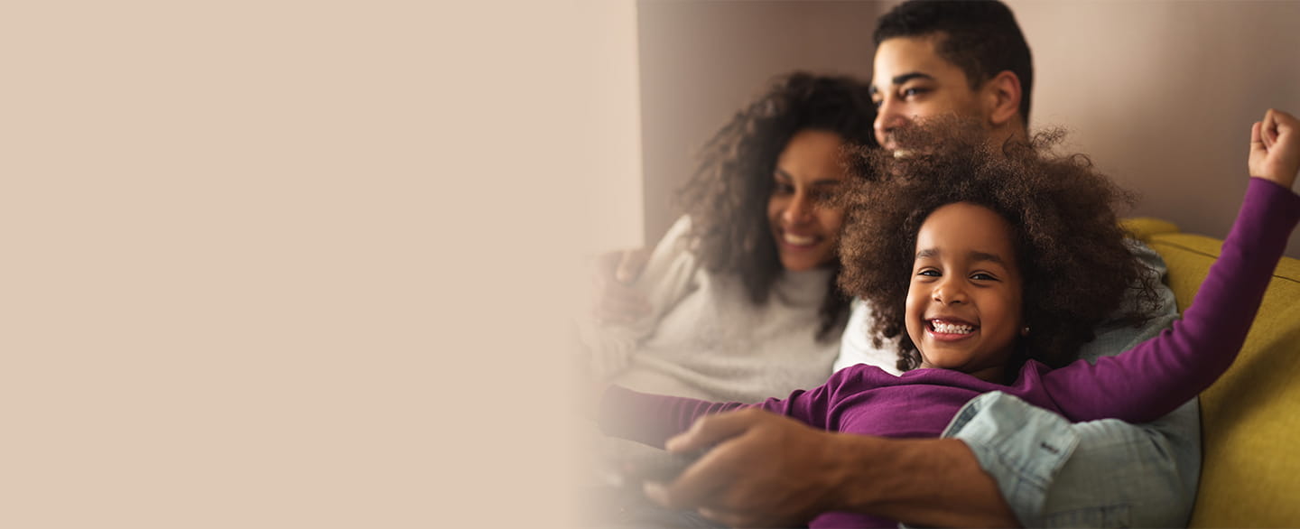 Young girl smiling with her family.