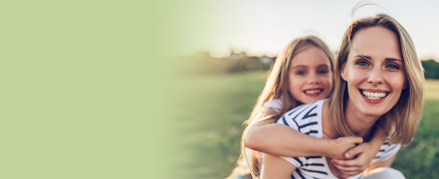 Happy mom and daughter outside.