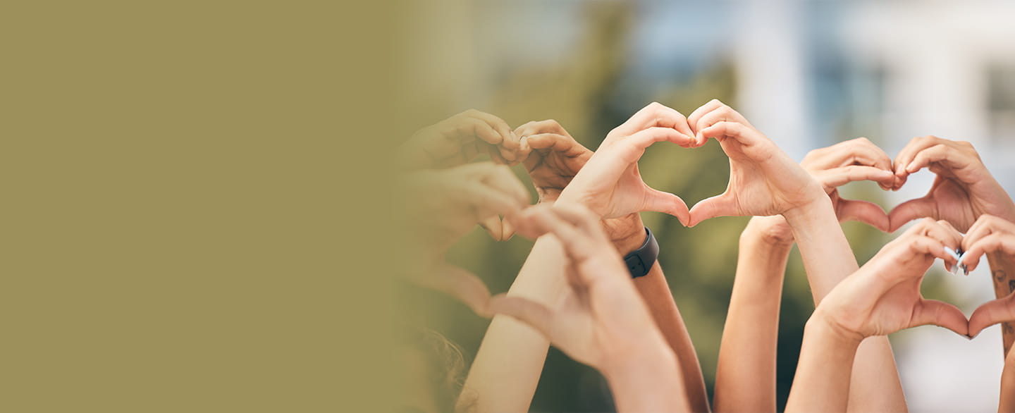 People lifting their hands up and making heart shapes with them