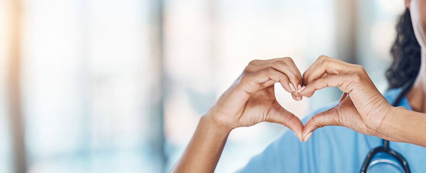 Doctor making a heart shape with her hands