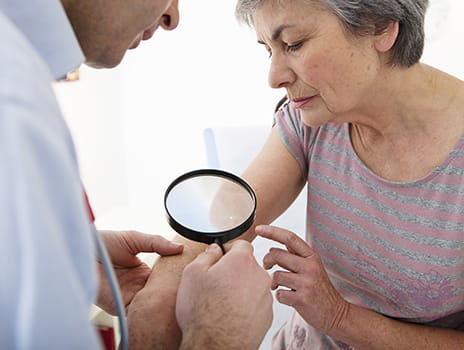 Women at dermatology appointment. 