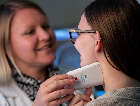 Doctor showing patient how to use Gamma Core device.