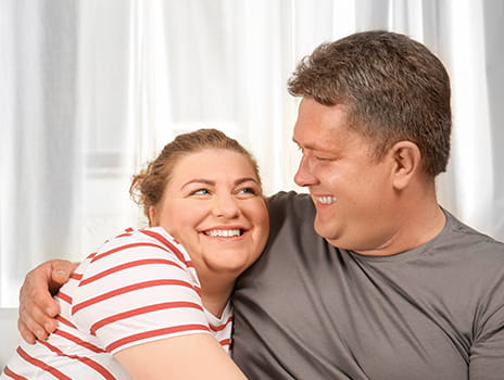 A couple smiling at each other