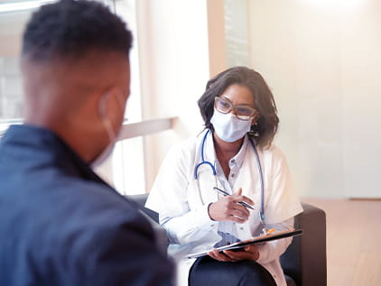 Person sitting with a doctor receiving a second opinion