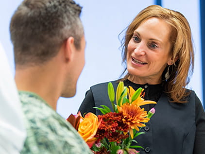 A volunteer speaking with a patient
