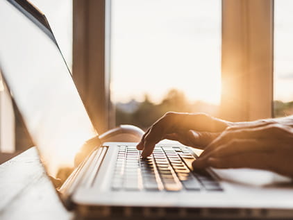 Photo of person typing on computer